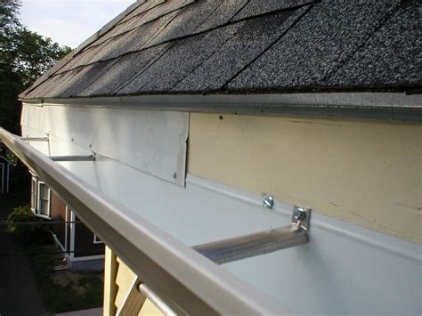 does guttering go over or under drip edge