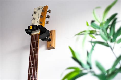 does hanging a guitar on the wall damage it