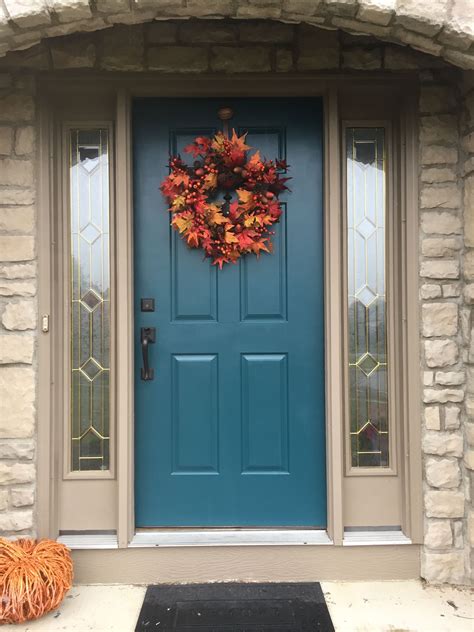 Cape Cod. Mint door. Fall. Leaves. White house. Black shutters. Stone