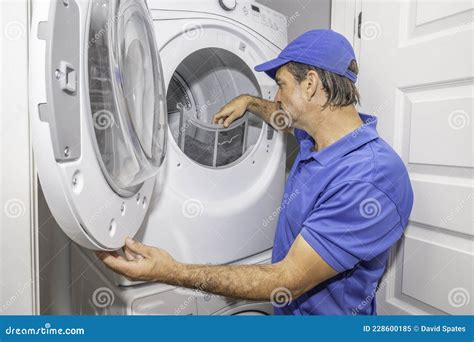 Dryer technician checking dryer