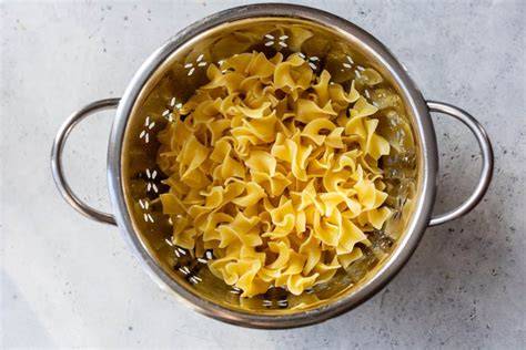 egg noodles into a colander