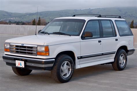 A classic 1994 Ford Explorer parked in a scenic outdoor setting, highlighting its rugged design.
