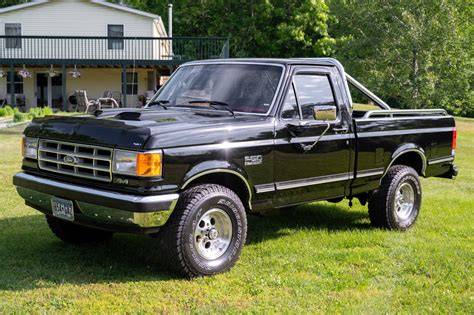 A classic 1987 Ford F-150 truck parked outdoors, showcasing its iconic design and robust build.