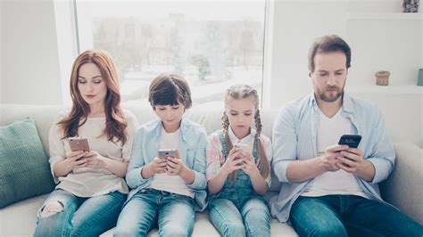 Happy family using smartphones together