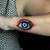 female evil eye tattoo