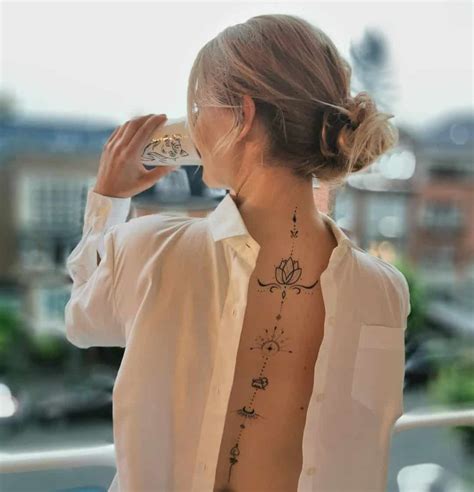 Informative Female Tattoo Designs For Spine Ideas