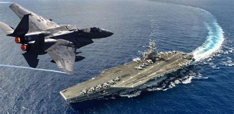 fighter jet landing on aircraft carrier