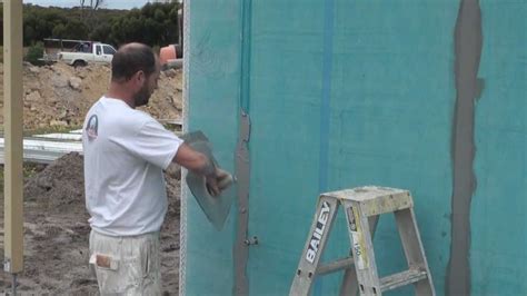 elyricsy.biz:fixing blue board sheets to a brick wall