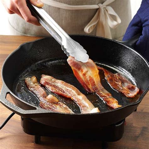 Flipping bacon with tongs