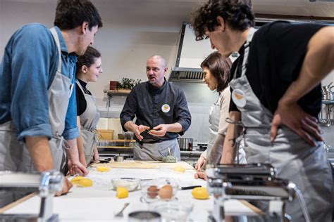 A small group of tourists enjoying a cooking class in Florence with a local chef.