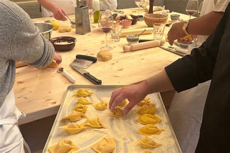 Group of people learning to cook traditional Italian dishes