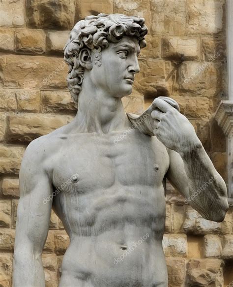 A person viewing the David statue from an elevated platform, capturing its majestic pose and proportions.