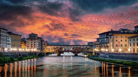 The Ponte Vecchio bathed in golden hues of sunset