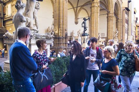 A group of tourists enjoying a walking tour in the heart of Florence.