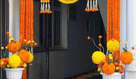 Door decor for Diwali with flower garlands and a Ganesh diya Door