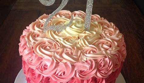 a pink and white cake with gold lettering on top