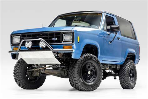 Classic Ford Bronco II parked on a scenic trail