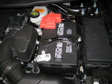 A close-up of a new Ford Explorer battery being installed