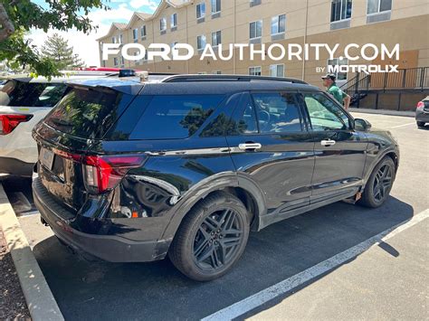 Sleek Ford Explorer Black SUV driving on a city street
