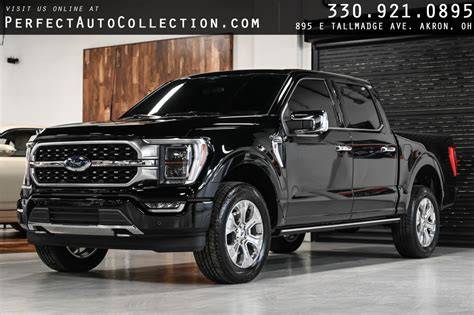 A powerful and versatile used Ford F-150 truck parked on a gravel lot, showcasing its rugged design and capability