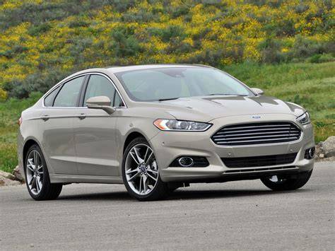 Front view of a silver 2015 Ford Fusion parked on a street