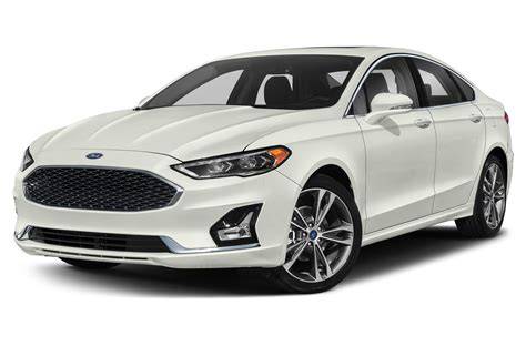 A sleek silver 2020 Ford Fusion parked on a city street