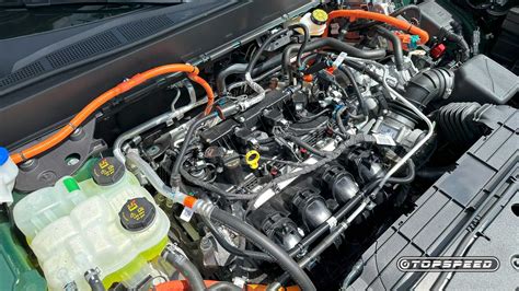 Mechanic performing maintenance on a Ford Maverick engine