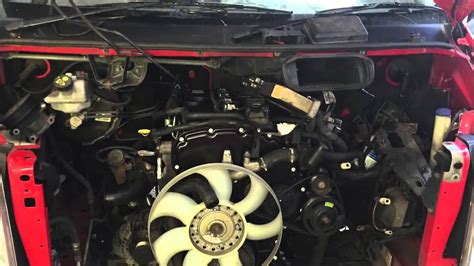Mechanic performing routine engine maintenance on a Ford Transit van