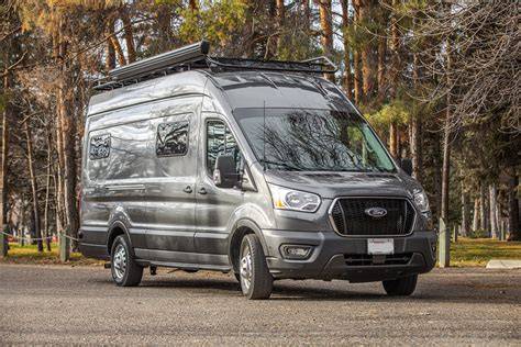 A spacious Ford Transit high roof van parked outdoors, showcasing its impressive height.