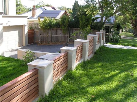 This sweet front yard is really made by the beautiful timber fence with