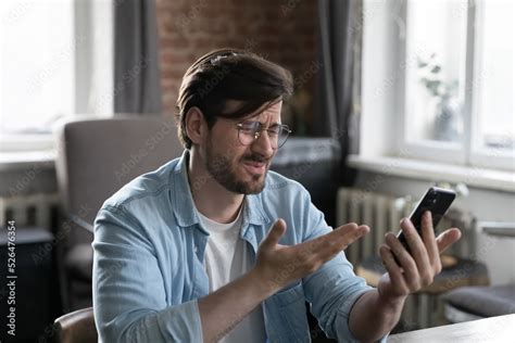 Frustrated man looking at phone with error message