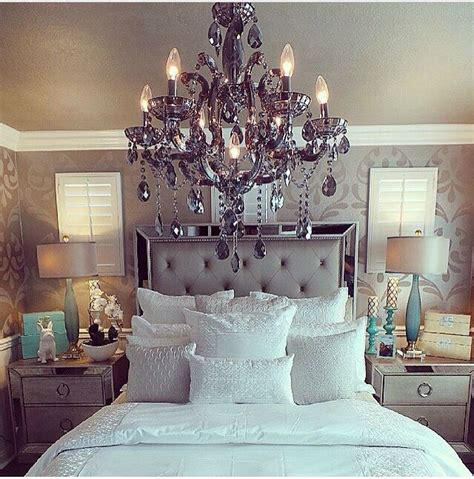 Image of a grey bedroom with a crystal chandelier