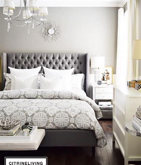 Image of a grey bedroom with a tufted headboard