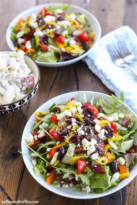 greek salad with potato salad on bottom