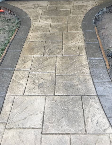 Gray Ashlar slate stamped concrete patio with stained black stained