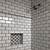 grey tiles black grout bathroom