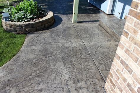 Gray Ashlar slate stamped concrete patio with stained black stained