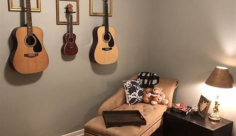 Guitars Displayed on Wall. Vintage gold frames. Home music rooms