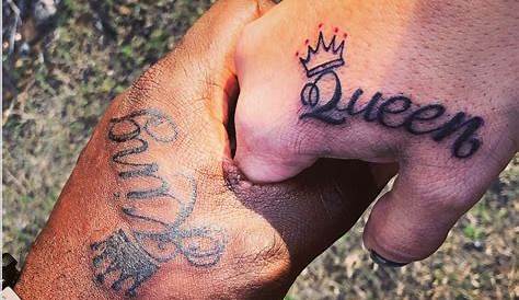A stylized pair of king and queen crowns tattoos on hand
