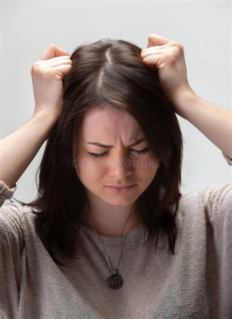 A person with their head in their hands, overwhelmed by work.