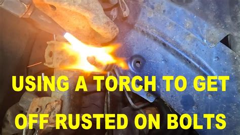 Heating a stubborn bolt with a torch