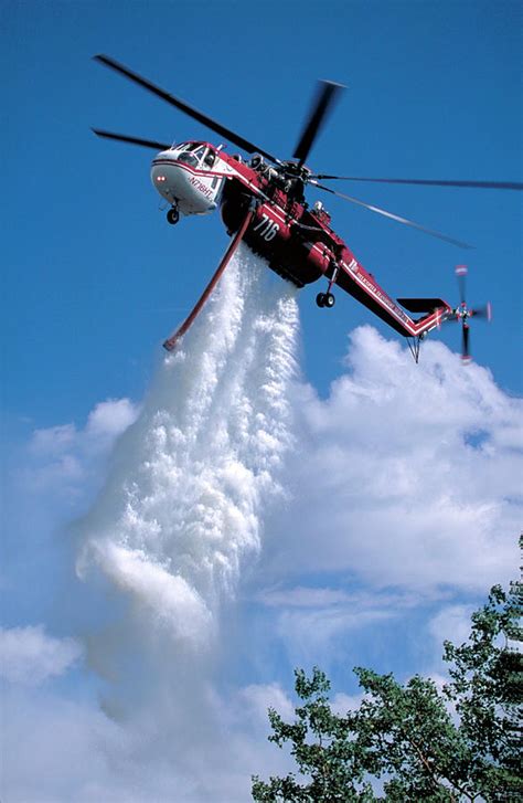 helicopter dropping water on fire