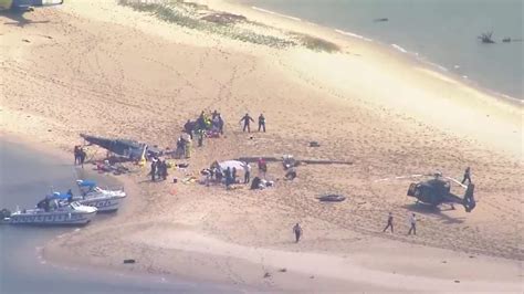 helicopters collide over australia beach