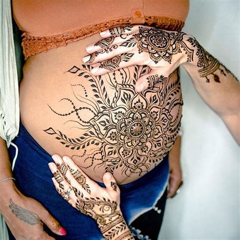 Stomach henna tattoos Pregnant belly with henna tattoo