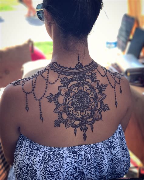 Initials with dandelion on the upper back henna tattoo