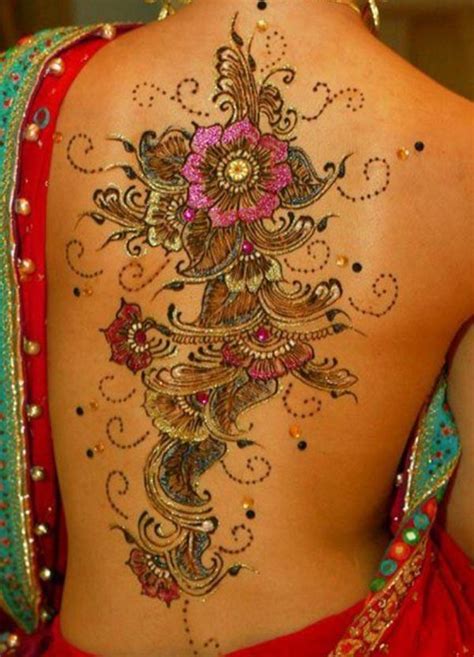 Black henna tatto design on a back. A henna tattoo is a