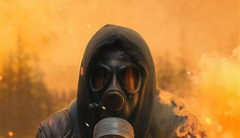Person in Orange Hoodie Wearing Gas Mask · Free Stock Photo