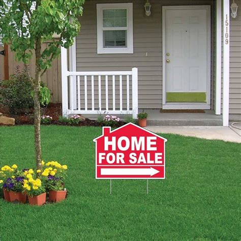 Image of a house with a "for sale" sign in the front yard.