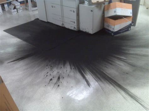 how do you pick up spilled toner from floor
