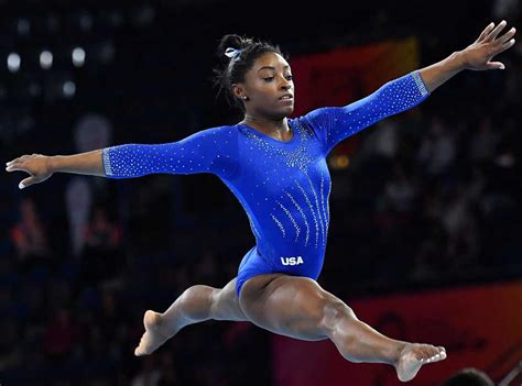 how tall is simone biles in inches